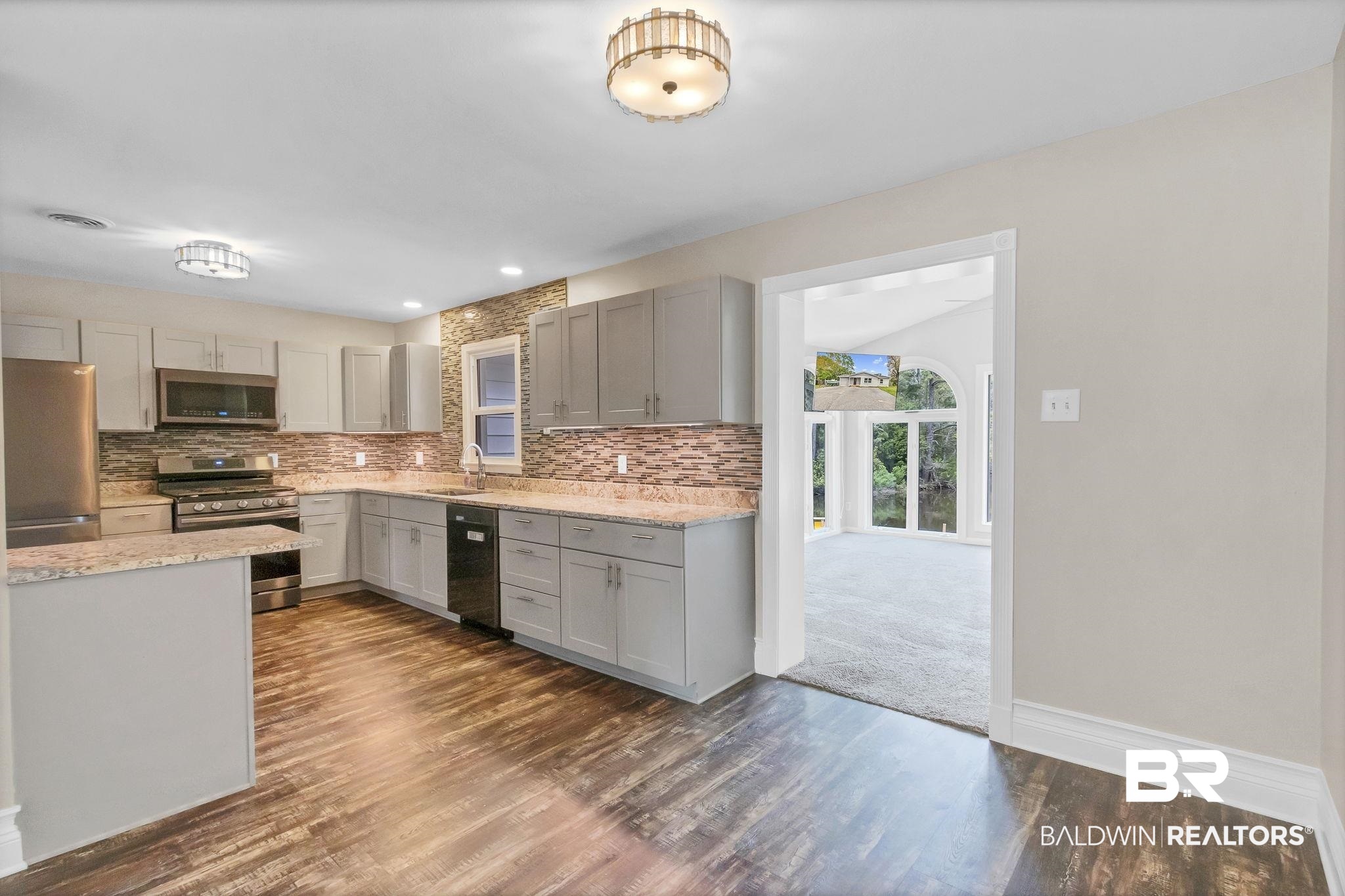 2901 Alston Court Mobile, AL 36605 - Photo 11 of 59 Kitchen with backsplash, stainless steel appliances, dark wood-type flooring, and gray cabinetry