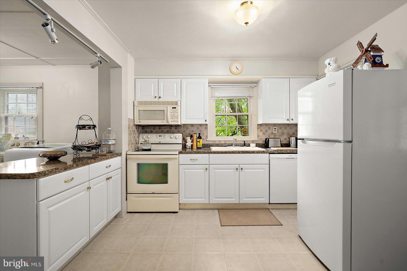 1001 Riverside Drive Salisbury, MD 21801 - Photo 21 of 47 a kitchen with white cabinets and white appliances