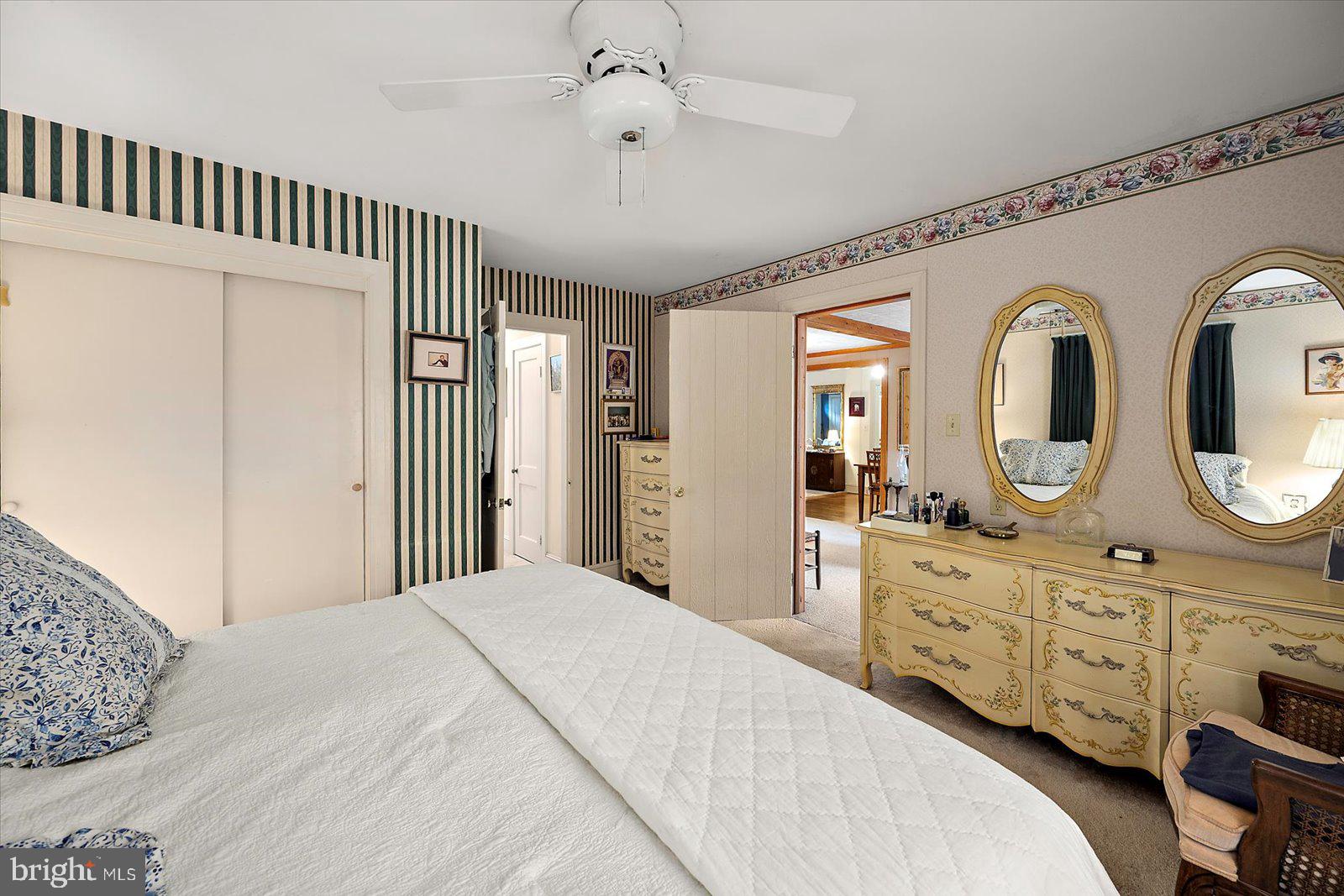 1001 Riverside Drive Salisbury, MD 21801 - Photo 28 of 47 a bedroom with a bed a mirror on dresser and a chandelier