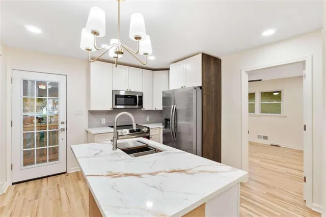 a kitchen with a sink a stove and microwave