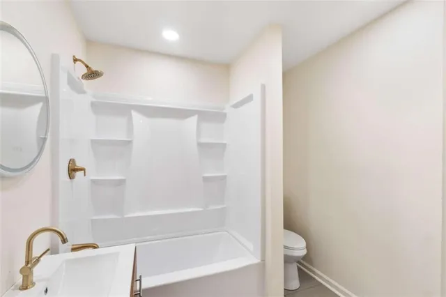 an empty room with a window and ceiling fan