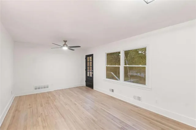 wooden floor in an empty room with a window