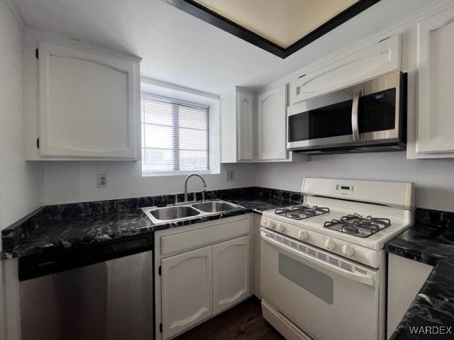 1190 Ramar Road, Unit 46 Bullhead City, AZ 86442 - Photo 15 of 36 a kitchen with stainless steel appliances granite countertop white cabinets granite counter tops and a stove