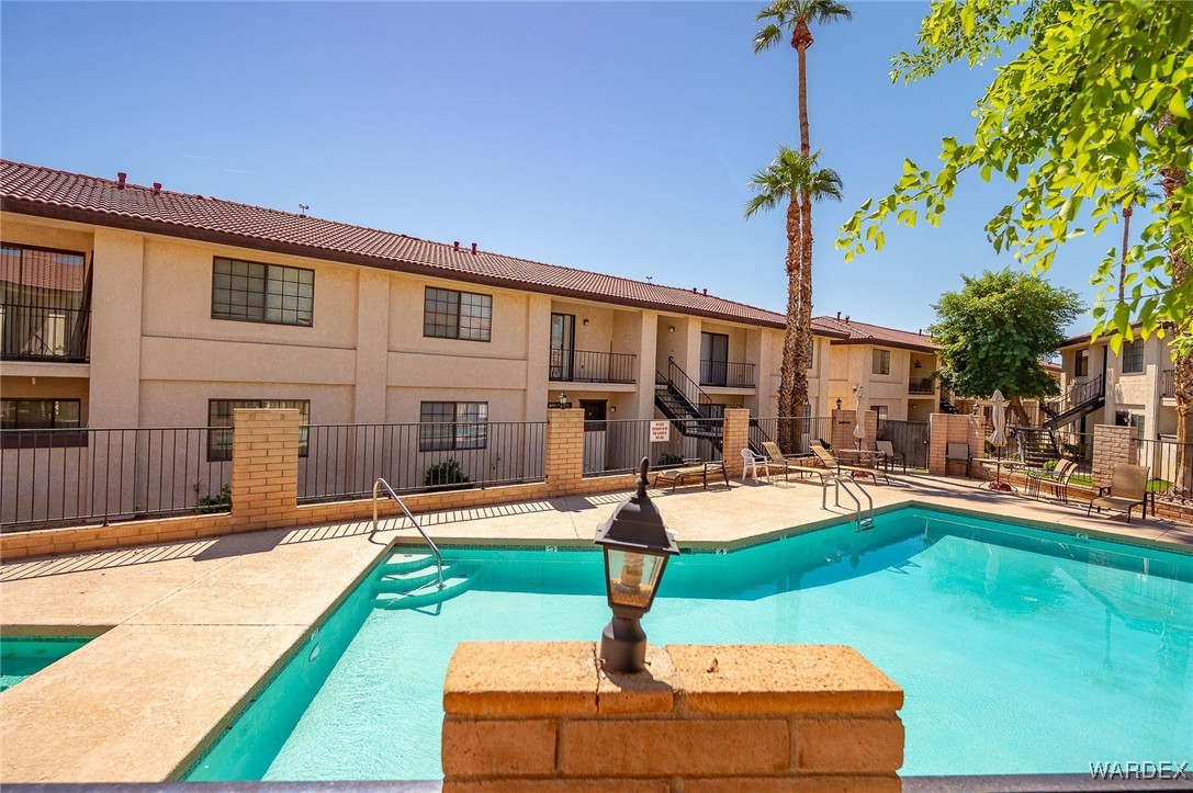 1190 Ramar Road, Unit 46 Bullhead City, AZ 86442 - Photo 36 of 36 a front view of a house with swimming pool patio and outdoor seating