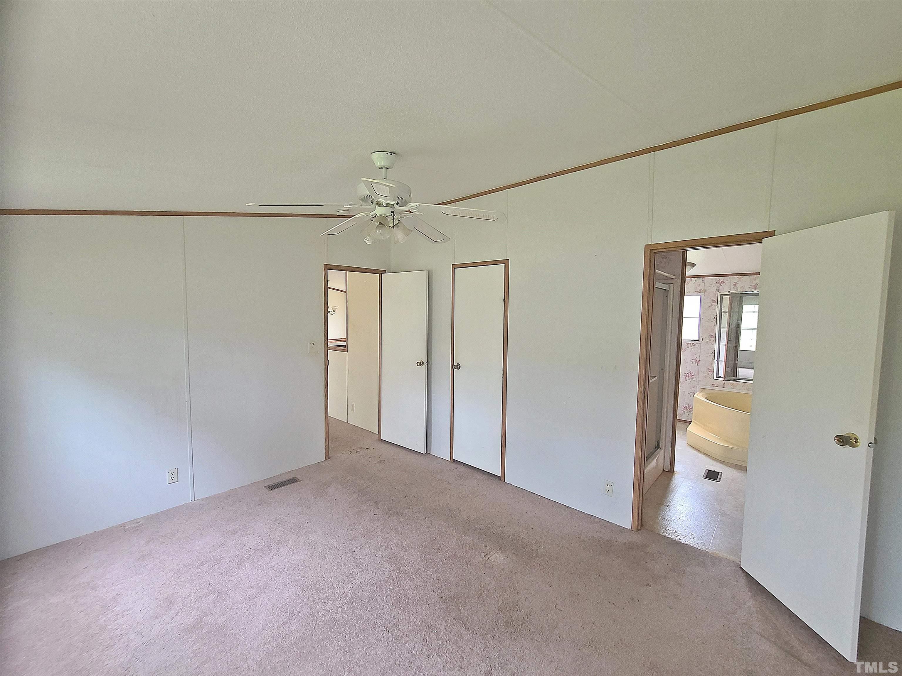 95 Moore Perkerson Road Spring Hope, NC 27882 - Photo 12 of 31 an empty room with chandelier fan