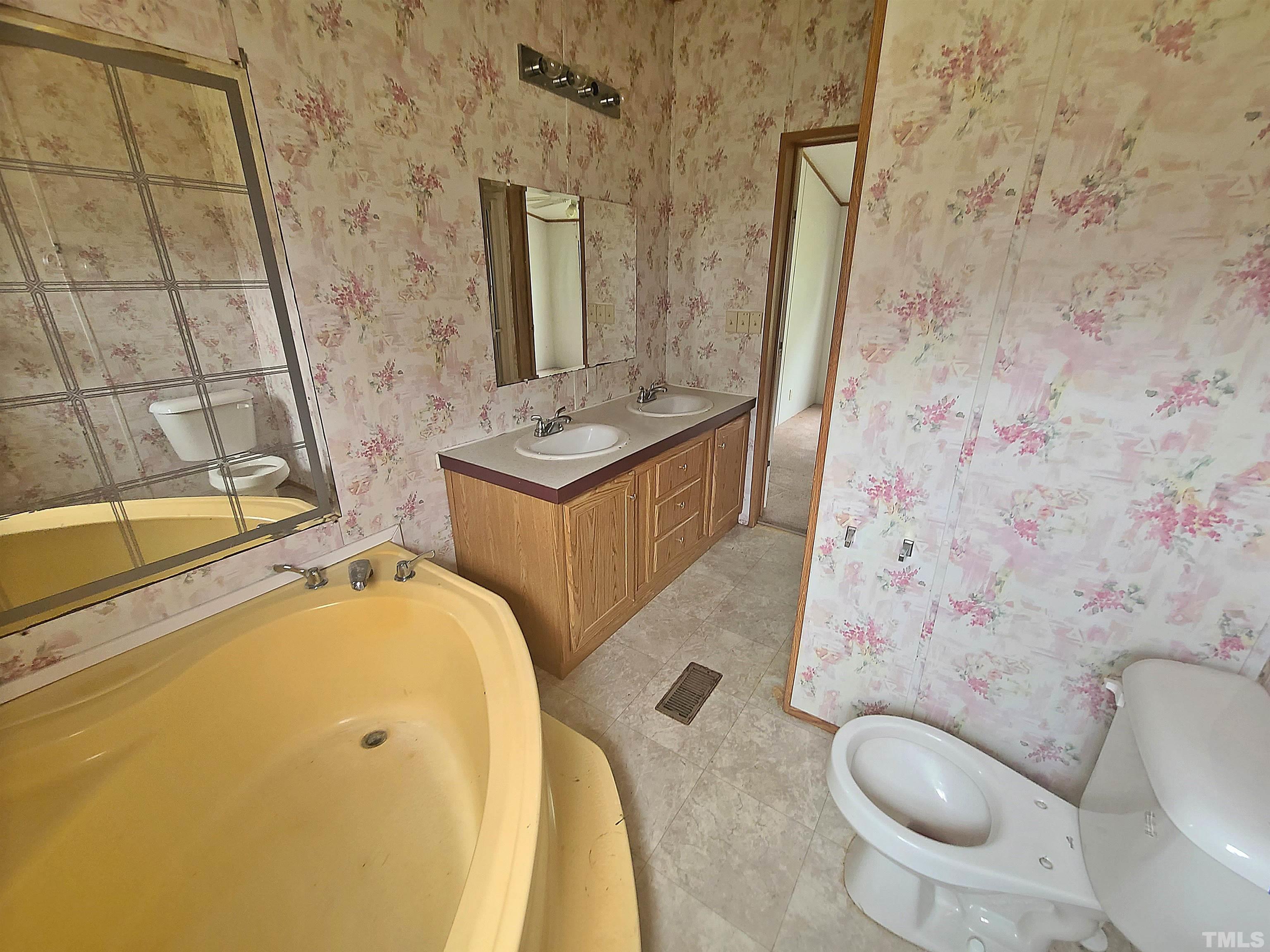 95 Moore Perkerson Road Spring Hope, NC 27882 - Photo 14 of 31 a bathroom with a granite countertop toilet sink and mirror