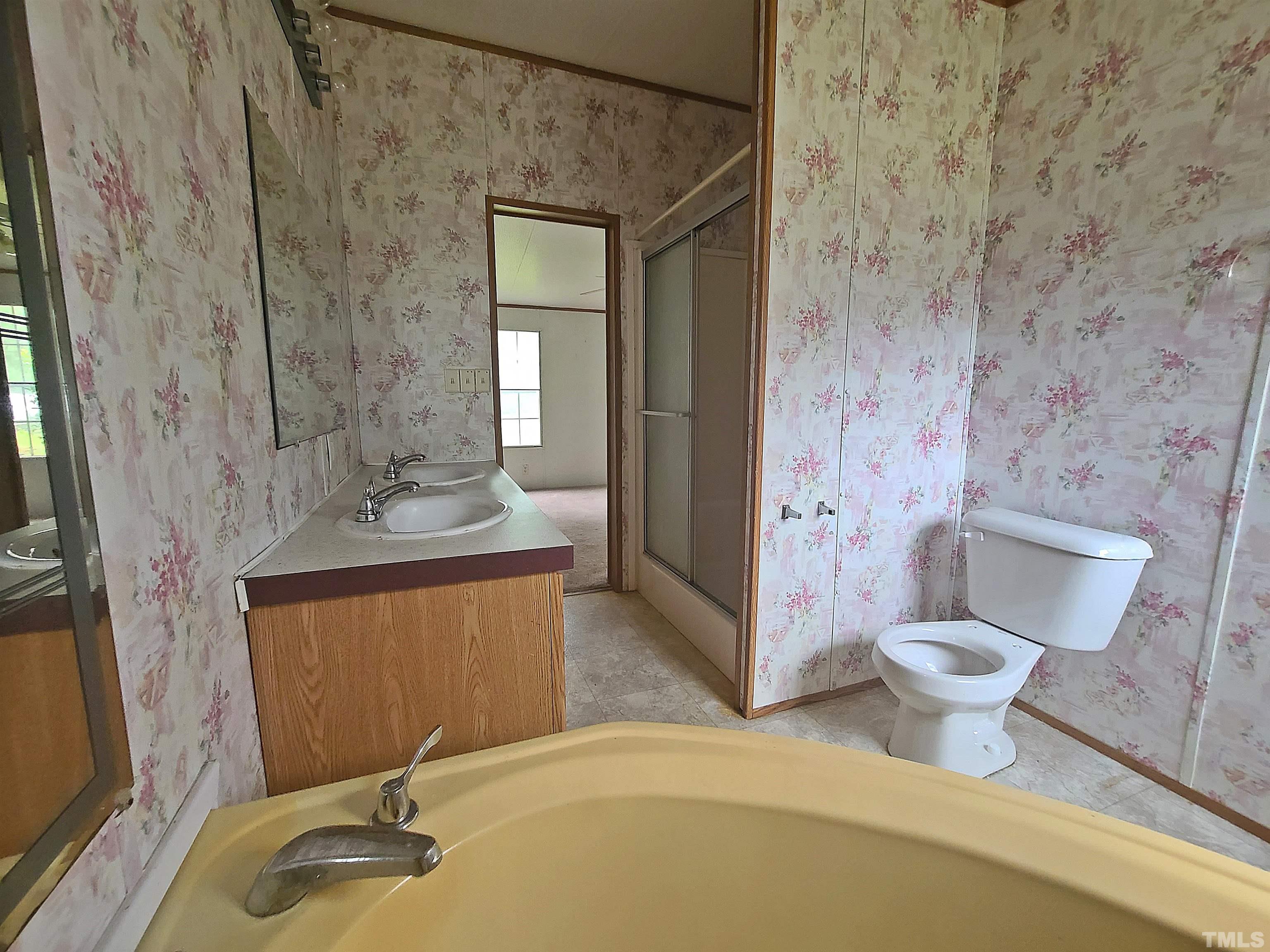 95 Moore Perkerson Road Spring Hope, NC 27882 - Photo 15 of 31 a bathroom with a granite countertop sink toilet and shower