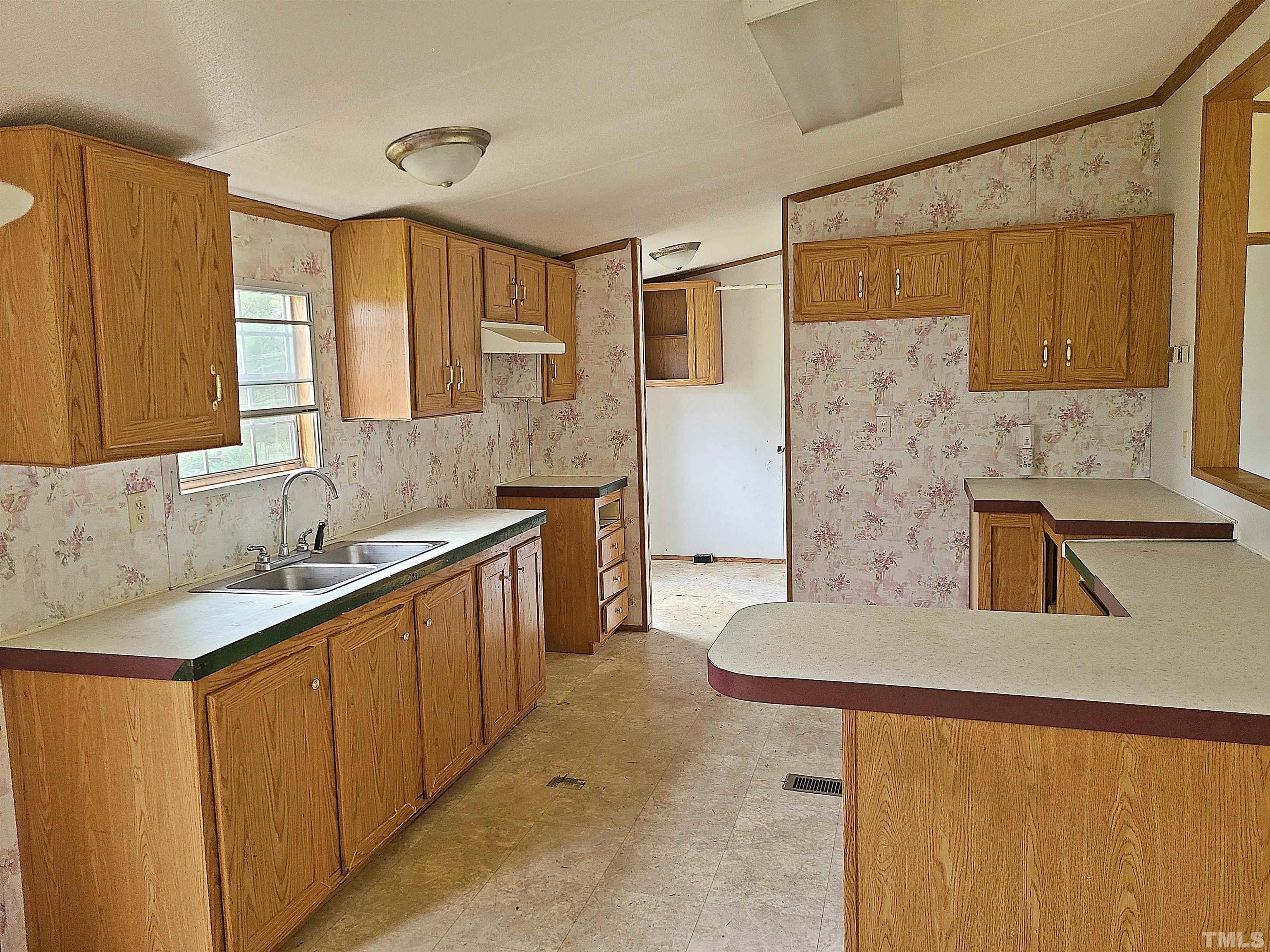 95 Moore Perkerson Road Spring Hope, NC 27882 - Photo 19 of 31 a kitchen with stainless steel appliances granite countertop a sink and cabinets