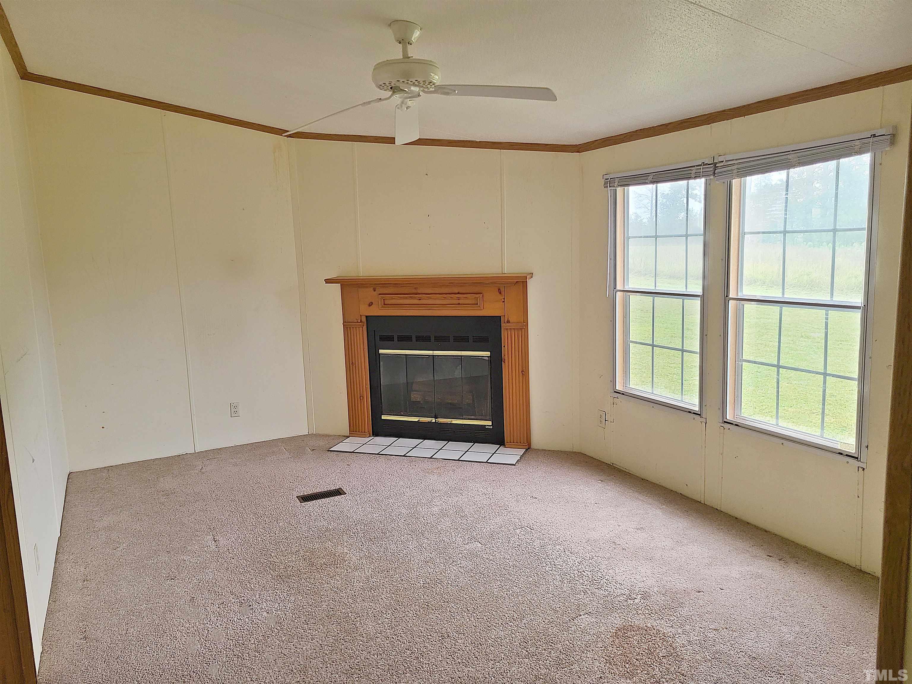 95 Moore Perkerson Road Spring Hope, NC 27882 - Photo 24 of 31 a view of an empty room with a fireplace and a window
