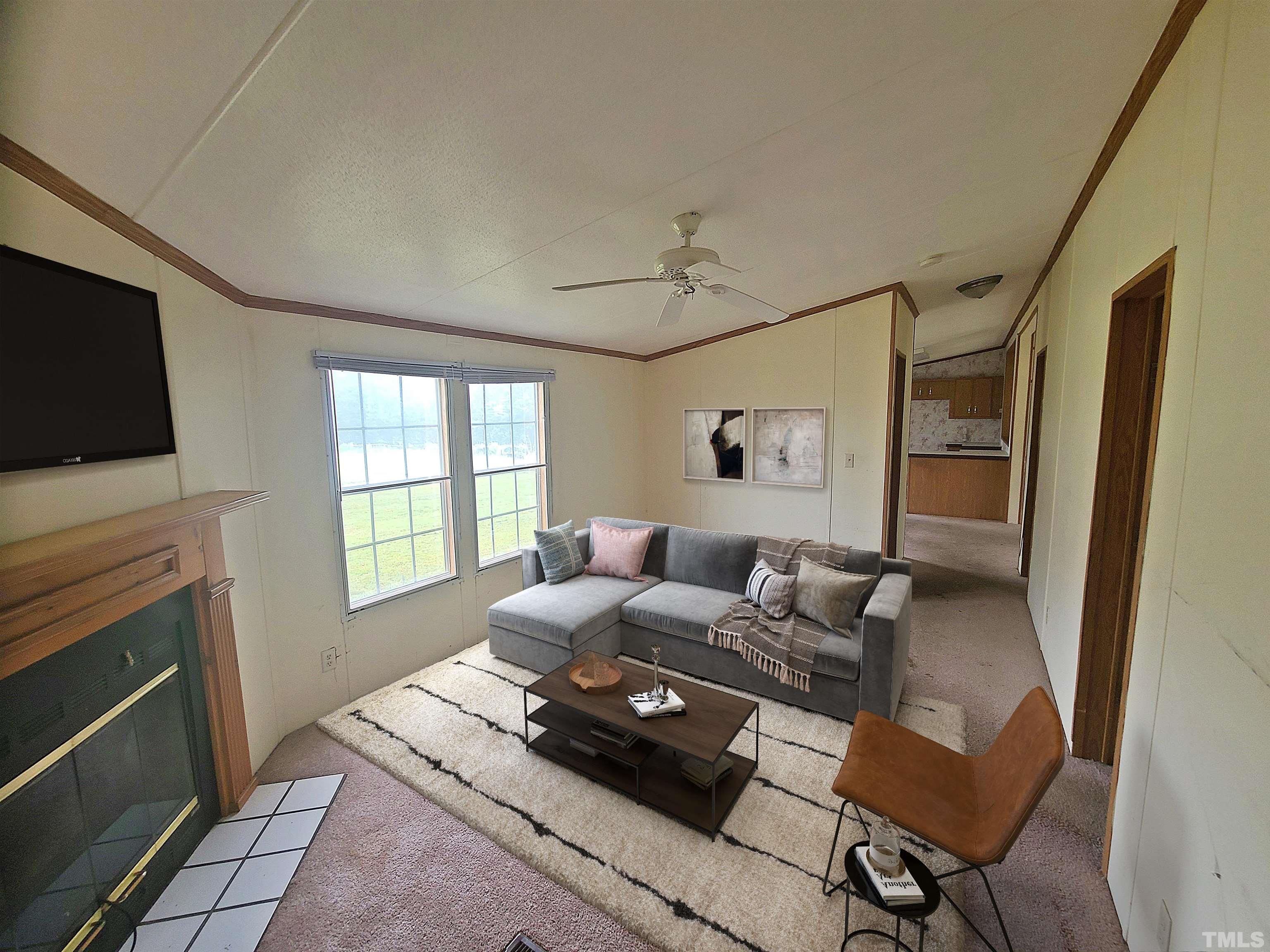95 Moore Perkerson Road Spring Hope, NC 27882 - Photo 25 of 31 a living room with furniture and a flat screen tv