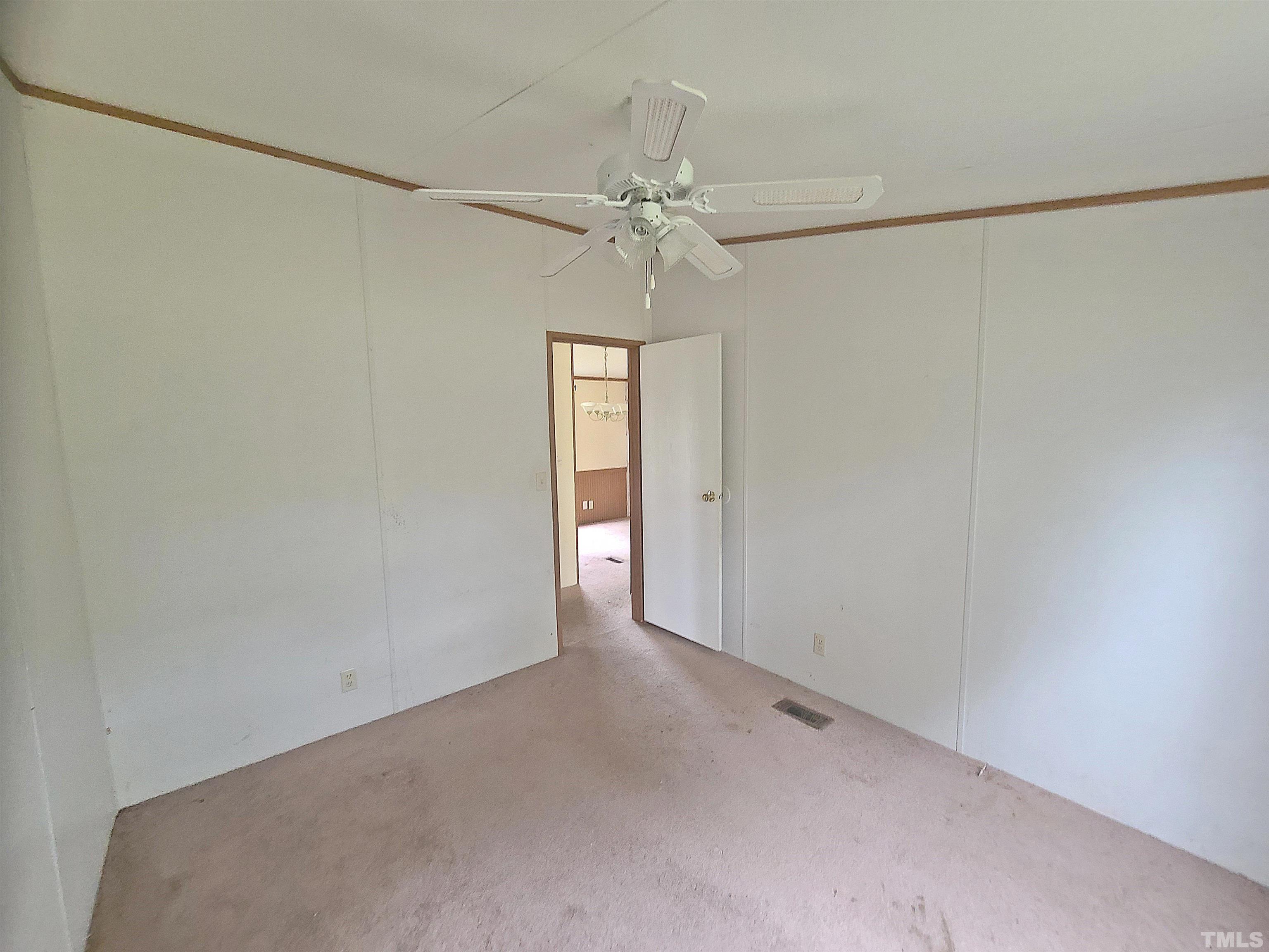 95 Moore Perkerson Road Spring Hope, NC 27882 - Photo 31 of 31 an empty room with a chandelier fan and windows