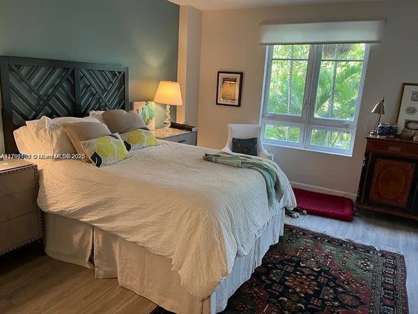 a bedroom with bed and window