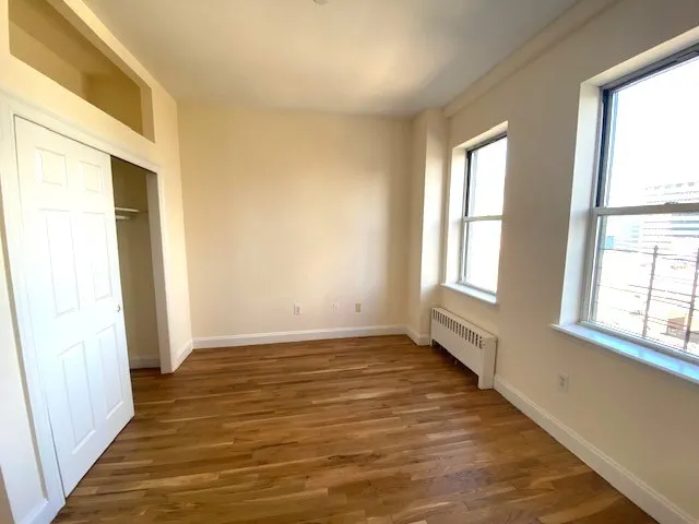 wooden floor in an empty room with a window