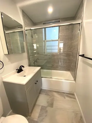 a bathroom with a sink mirror toilet and bathtub