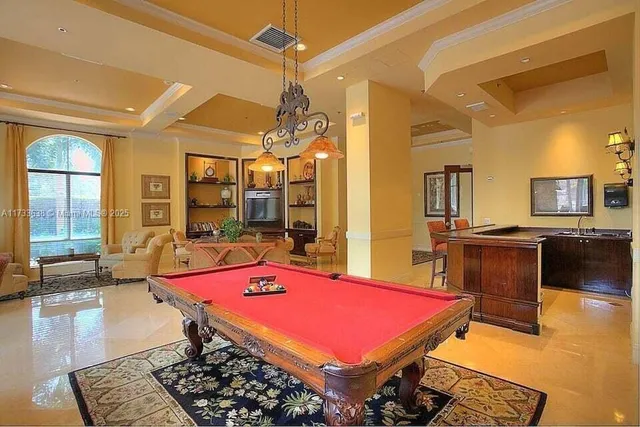 a room with pool table and large windows