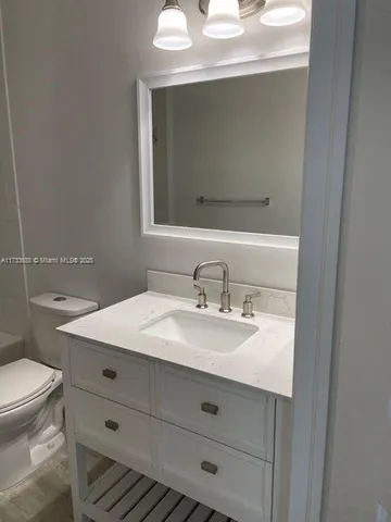 a bathroom with a sink toilet and vanity