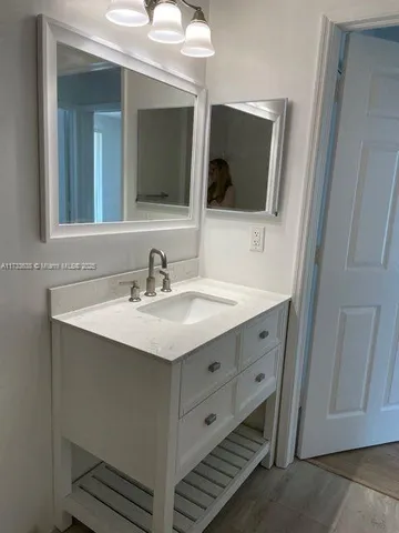a bathroom with a double vanity sink and mirror