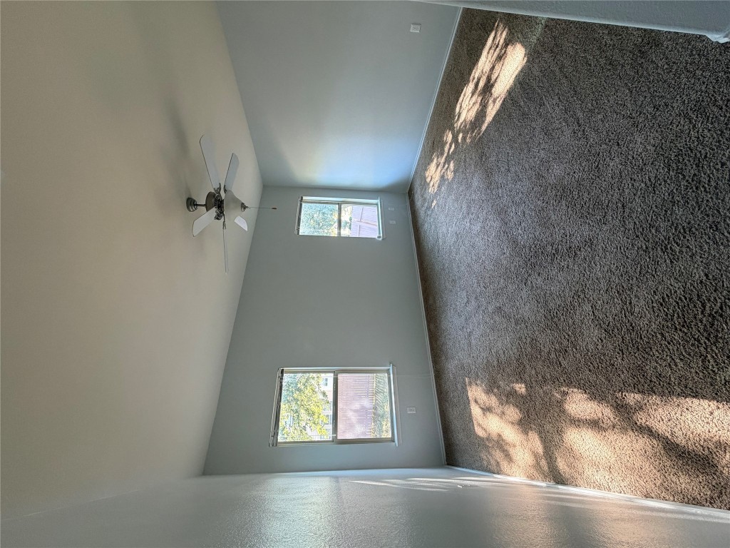 10204 Pinnacle Crest Loop Austin, TX 78747 - Photo 11 of 19 an empty room with windows and ceiling fan view