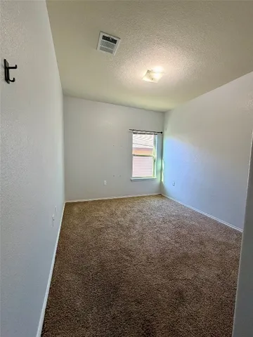 a view of a hallway with wooden floor and closet