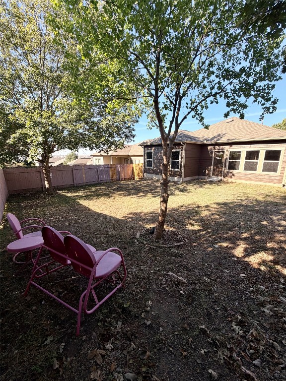 10204 Pinnacle Crest Loop Austin, TX 78747 - Photo 19 of 19 a backyard of a house with barbeque oven table and chairs