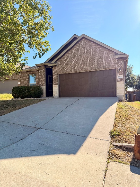 10204 Pinnacle Crest Loop Austin, TX 78747 - Photo 5 of 19 a front view of house with yard and trees in the background