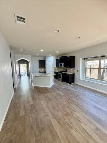 a view of kitchen with furniture and wooden floor