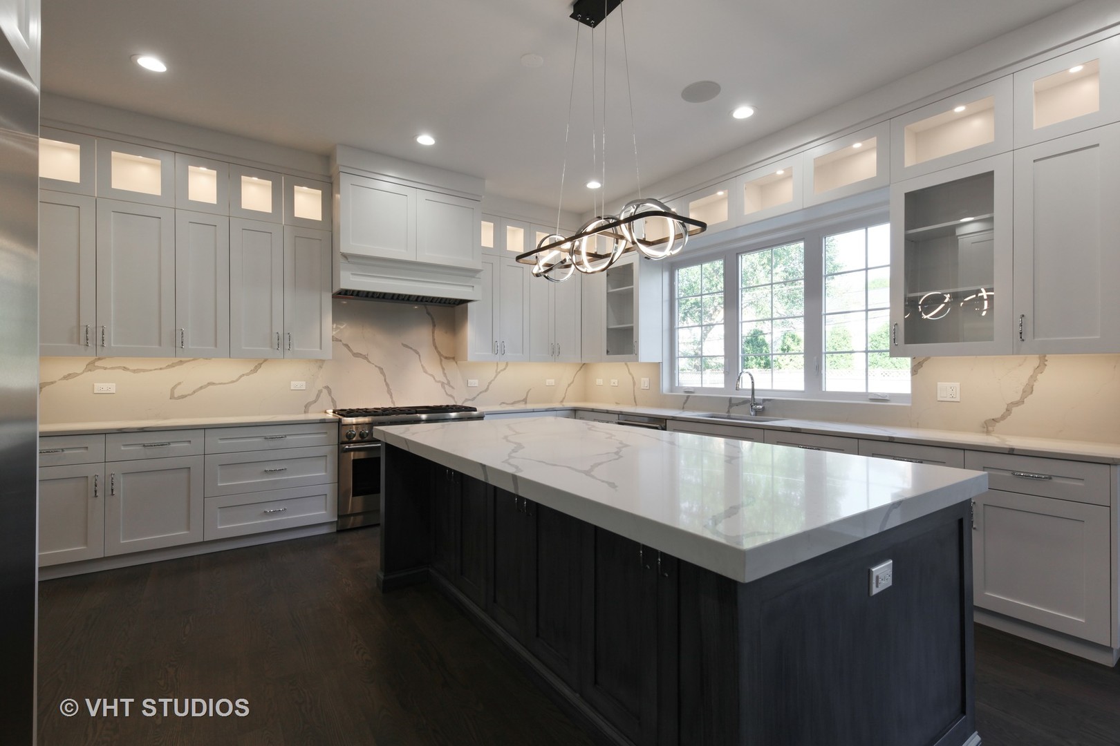 719 Juniper Road Glenview, IL 60025 - Photo 11 of 39 a kitchen with granite countertop a sink stove and cabinets
