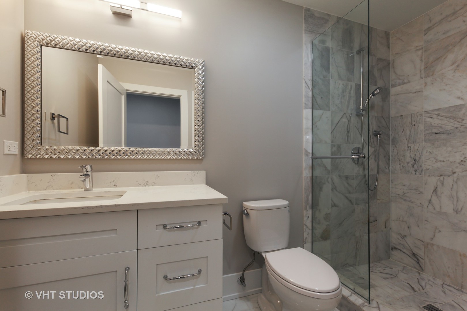 719 Juniper Road Glenview, IL 60025 - Photo 33 of 39 a bathroom with a toilet sink vanity and mirror