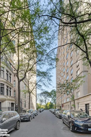 a view of a hallway with dining area and chandelier