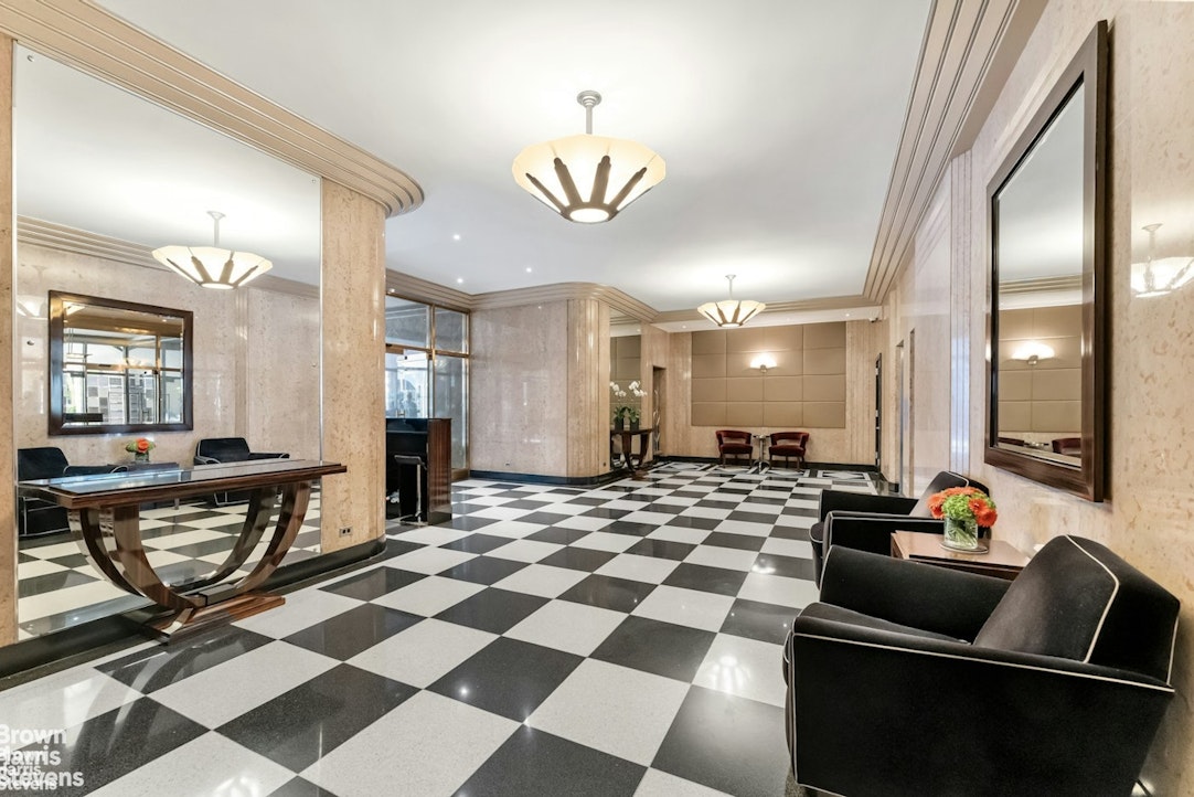 20 East 74th Street, Unit 8A Manhattan, NY 10021 - Photo 20 of 22 a living room with furniture and a dining table with kitchen view