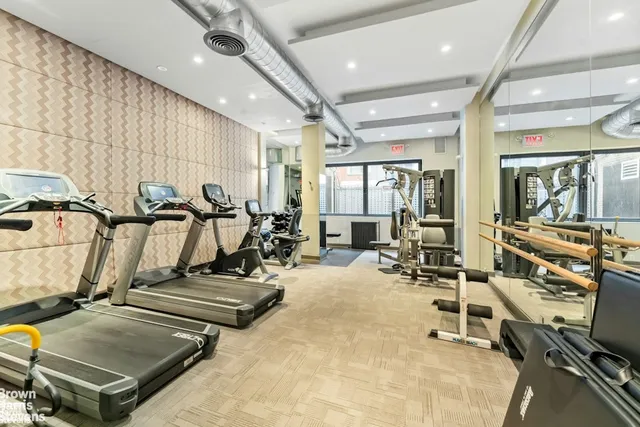 a living room with furniture and a dining table with kitchen view
