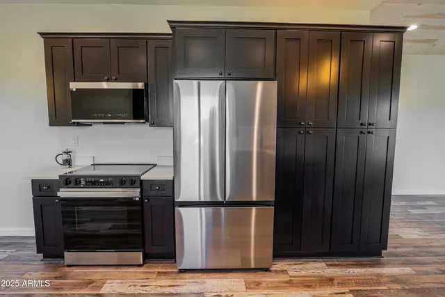 a kitchen with a refrigerator and a stove