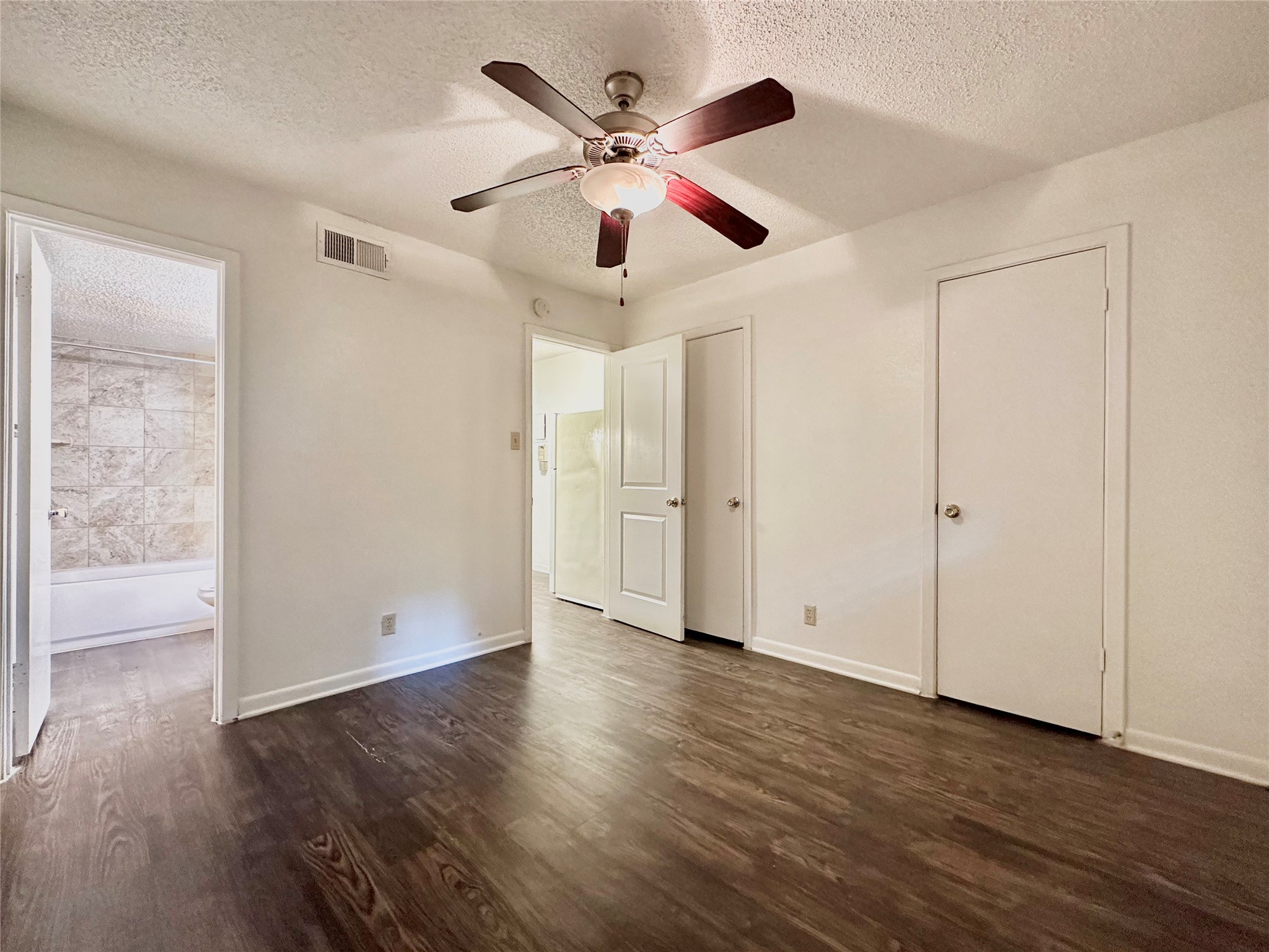 2808 Whitis Avenue, Unit C205 Austin, TX 78705 - Photo 4 of 7 a view of an empty room with wooden floor