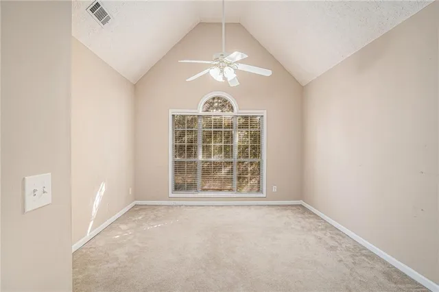 an empty room with a empty space and windows