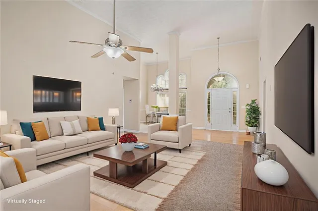 a living room with furniture a fireplace and a flat screen tv