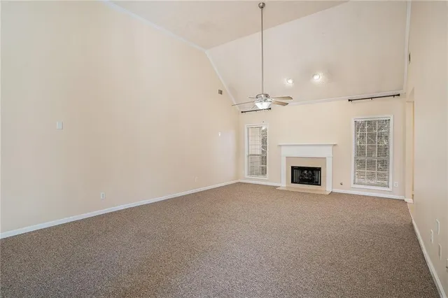 a view of a livingroom with a fireplace and chandelier fan