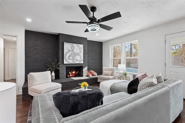 a living room with furniture a fireplace and a window