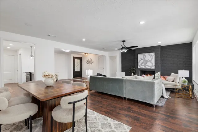 a living room with furniture a wooden floor and a chandelier