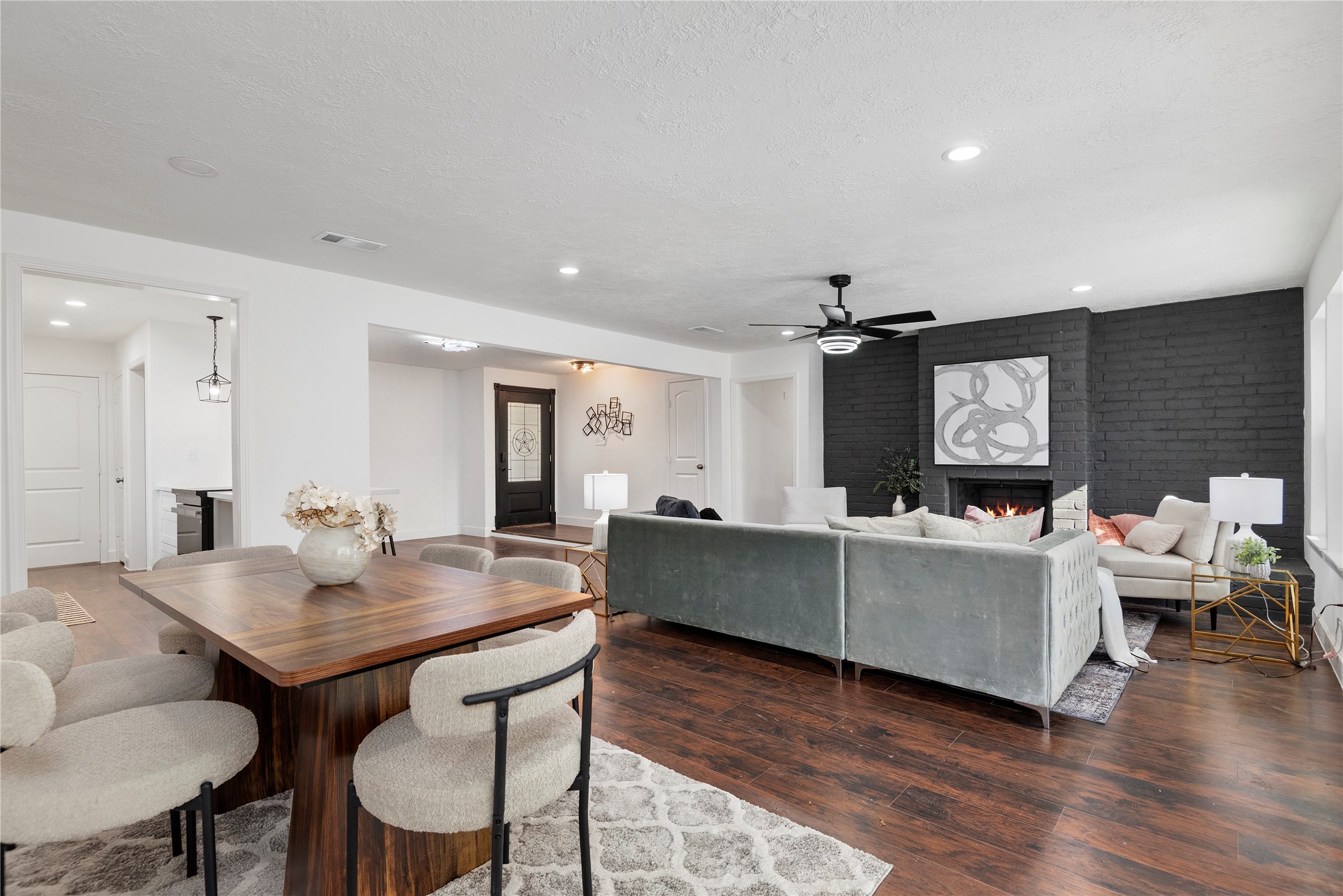 6126 Knotty Post Lane Spring, TX 77373 - Photo 17 of 18 a living room with furniture a wooden floor and a chandelier