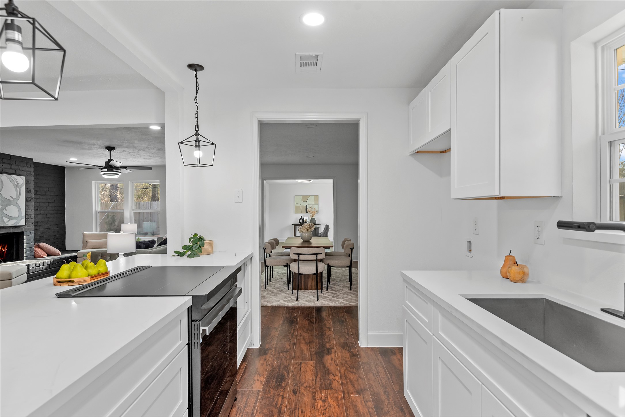 6126 Knotty Post Lane Spring, TX 77373 - Photo 4 of 18 a kitchen that has a lot of cabinets a sink and wooden floor