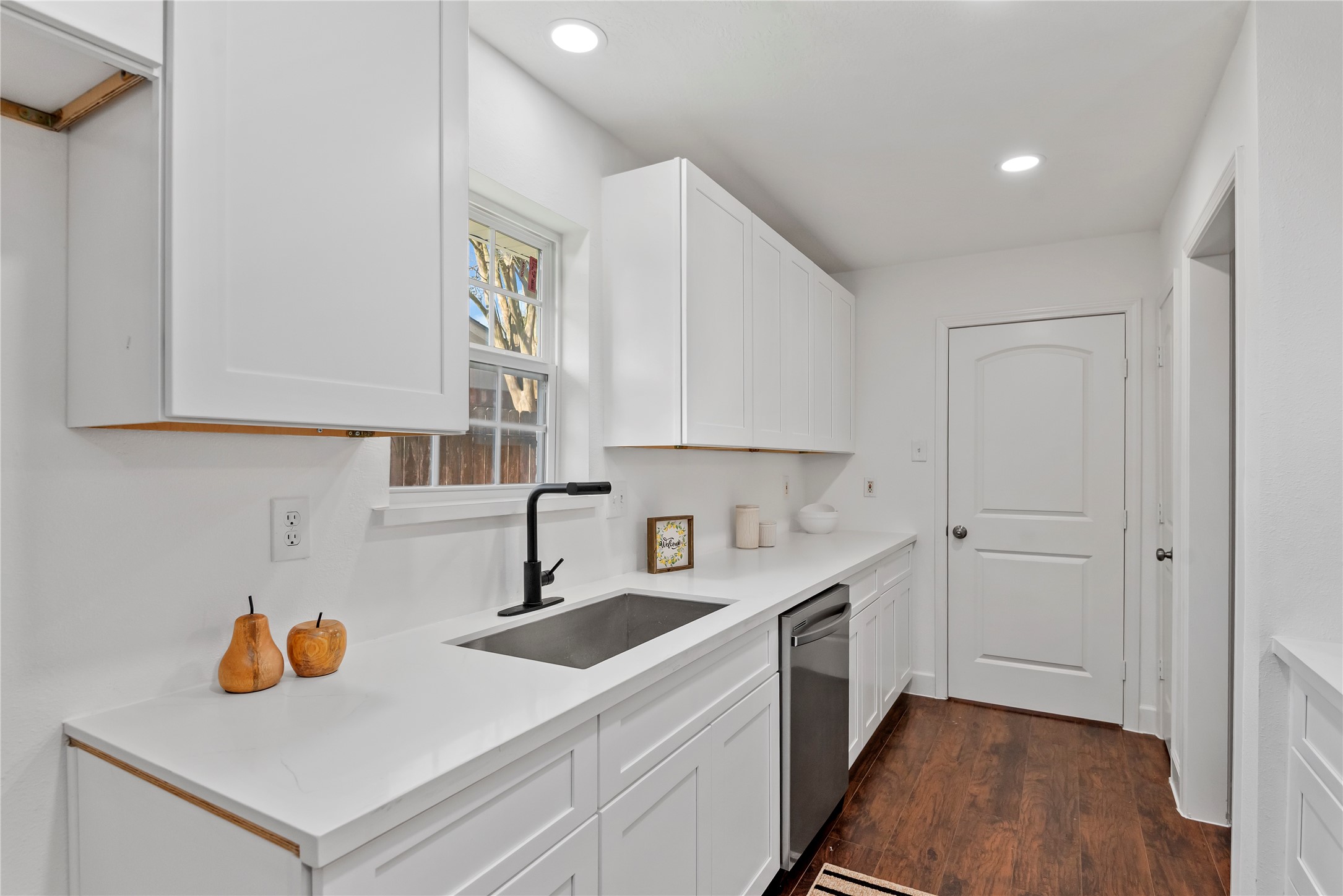 6126 Knotty Post Lane Spring, TX 77373 - Photo 7 of 18 a kitchen with a sink cabinets and wooden floor