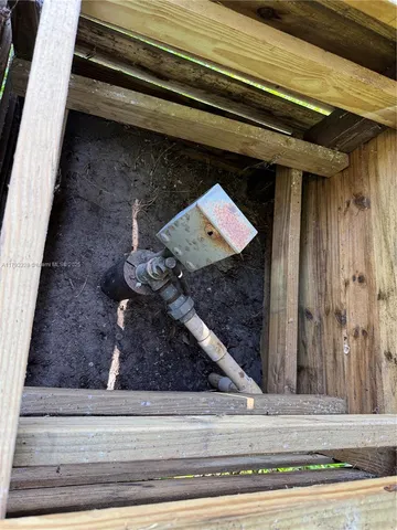 a kitchen with a sink and wooden floor