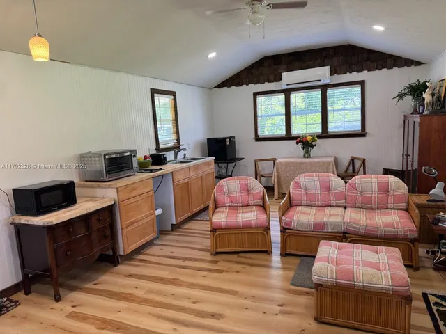 a spacious bedroom with two beds and a chandelier