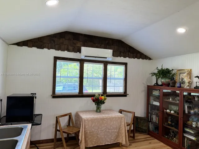 a view of a room with wooden floor and windows