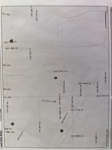 a view of a field of grass and trees