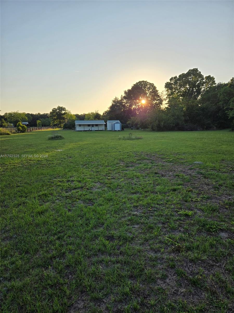 3725 Southwest 162nd Street Archer, FL 32618 - Photo 32 of 48 a view of a green field with an house in the background