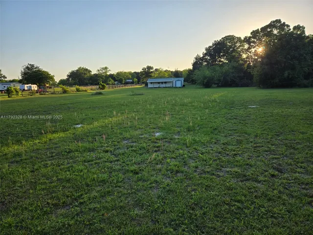 a view of a green field with clear sky