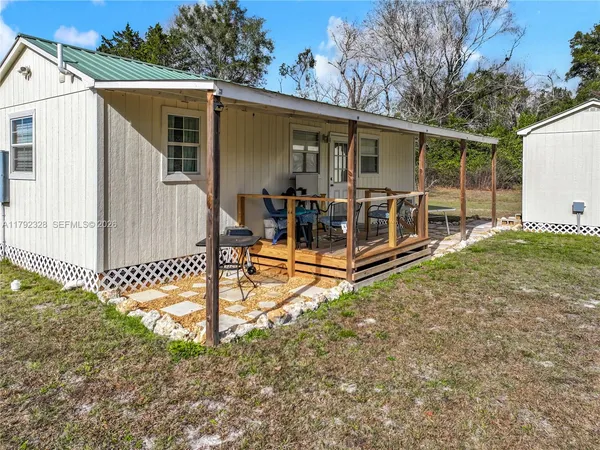 a view of a house with backyard porch and sitting area