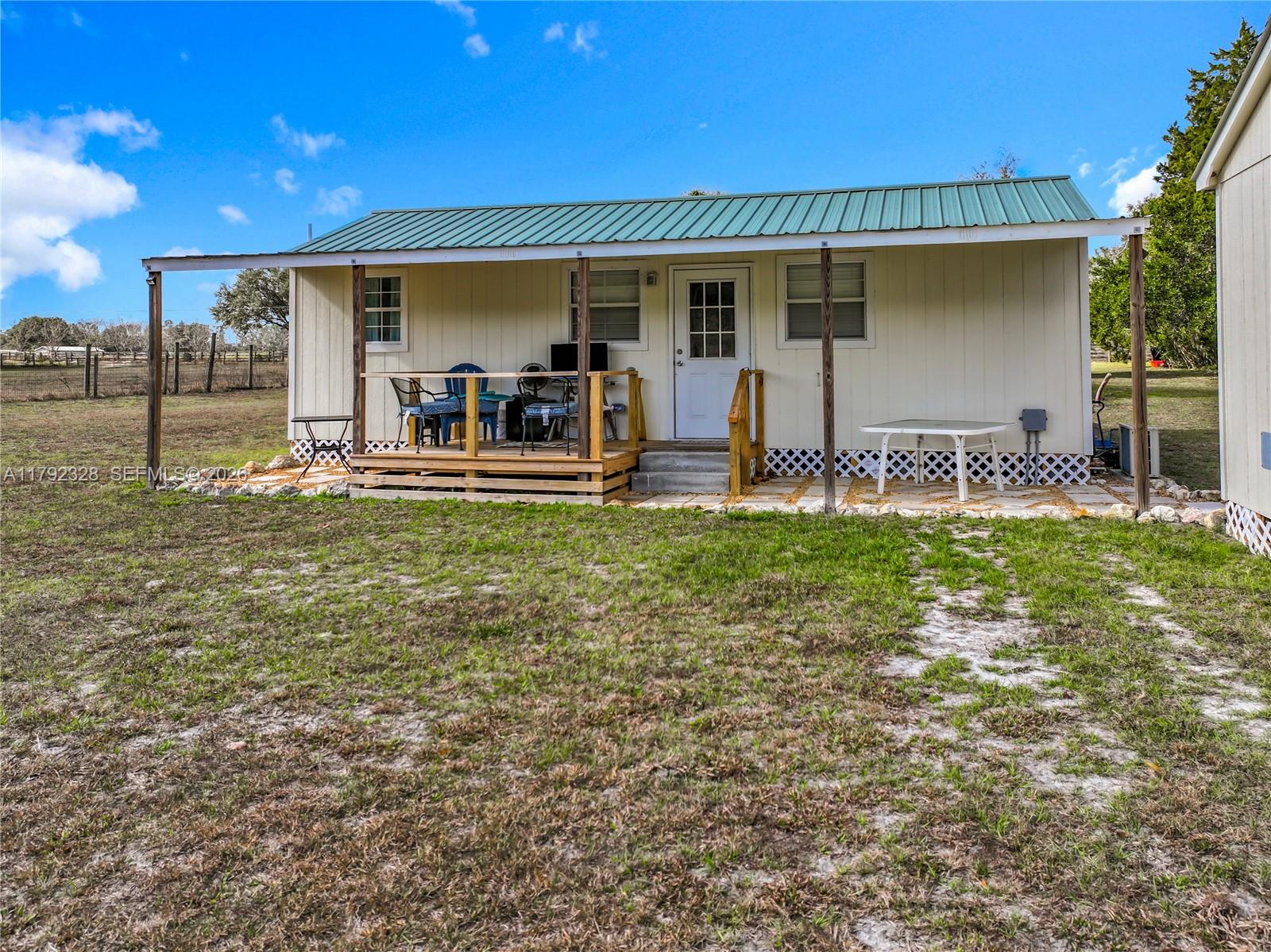 3725 Southwest 162nd Street Archer, FL 32618 - Photo 44 of 48 a view of a house with backyard porch and sitting area