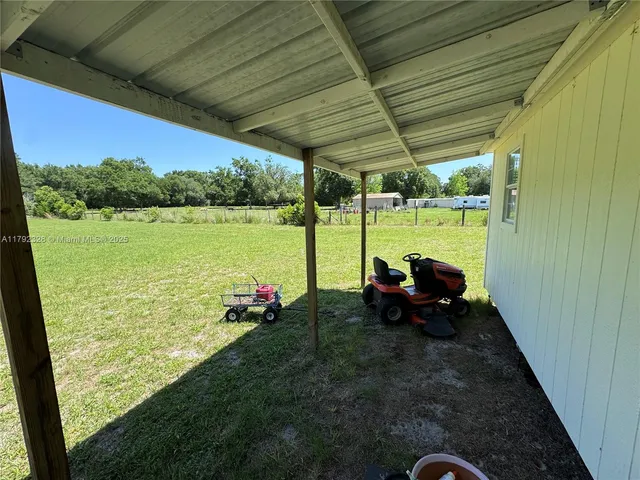 a backyard of a house with outdoor seating